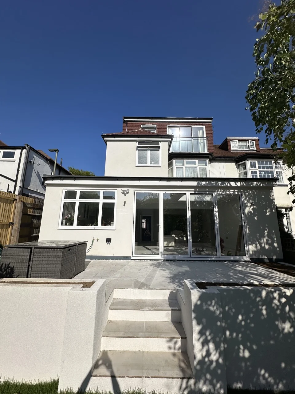 Porcelain patio and steps into the garden: Double-Storey Rear Extension in Hampstead by Alb Homes