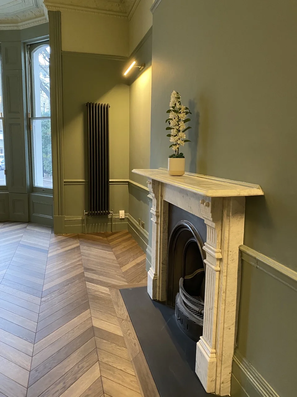 Restored fireplace and chevron parquet: Period Property Renovation in Kensington by Alb Homes