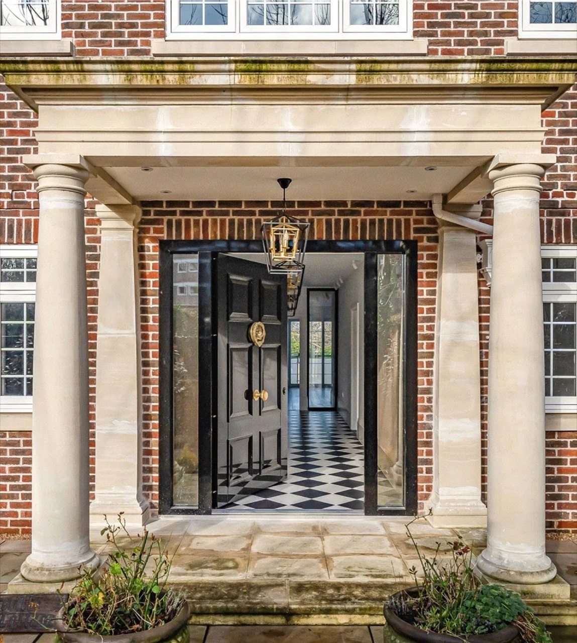 Stone portico entrance of a new build family home in Totteridge, North London, built by Alb Homes