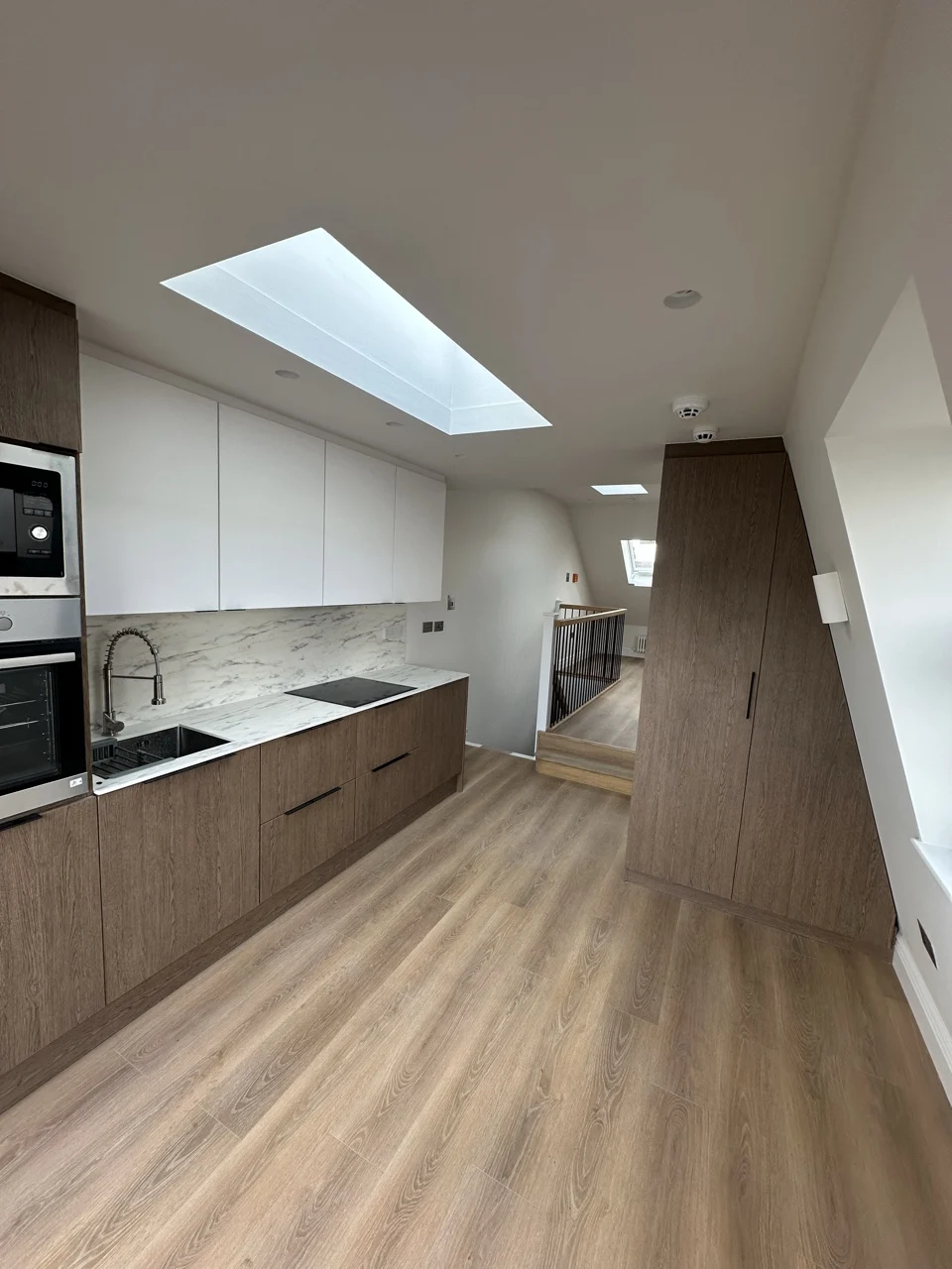 Kitchen and landing in the loft: Flat Conversion with New Loft in White City by Alb Homes