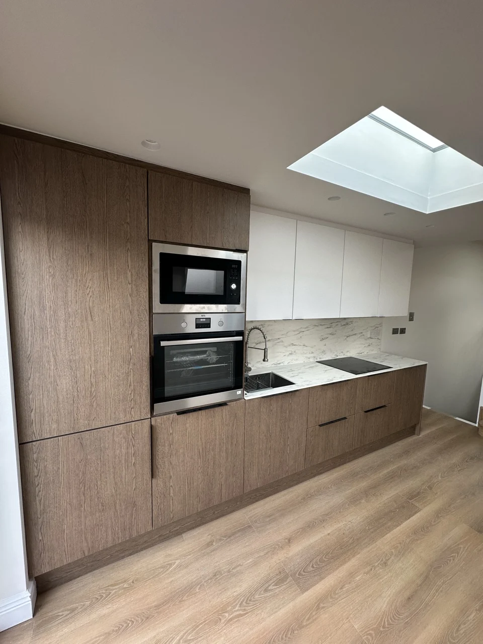 Loft kitchen with integrated ovens: Flat Conversion with New Loft in White City by Alb Homes