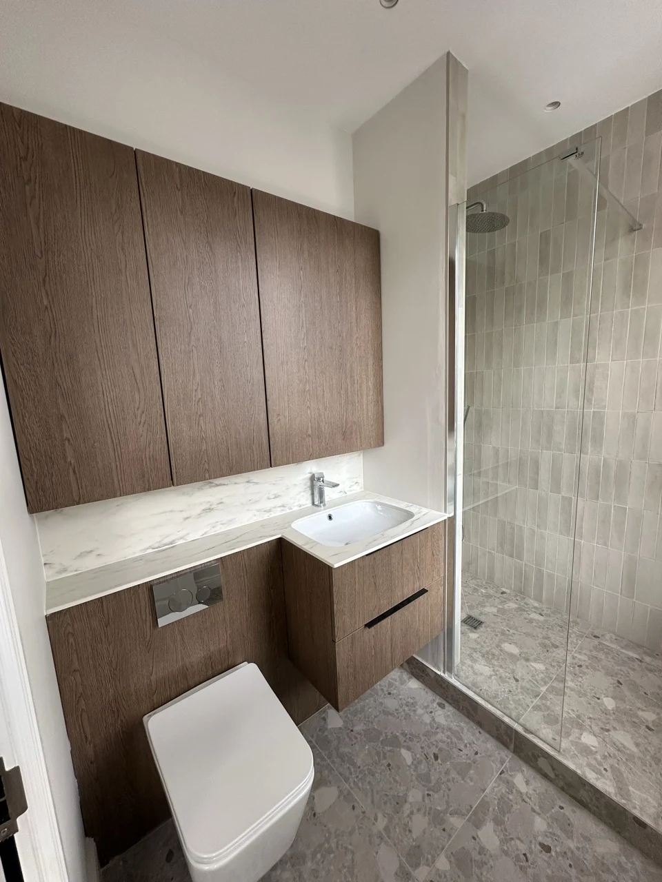 Shower room with a terrazzo floor: Flat Conversion with New Loft in White City by Alb Homes